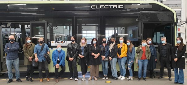 Picture of participant in front of a bus